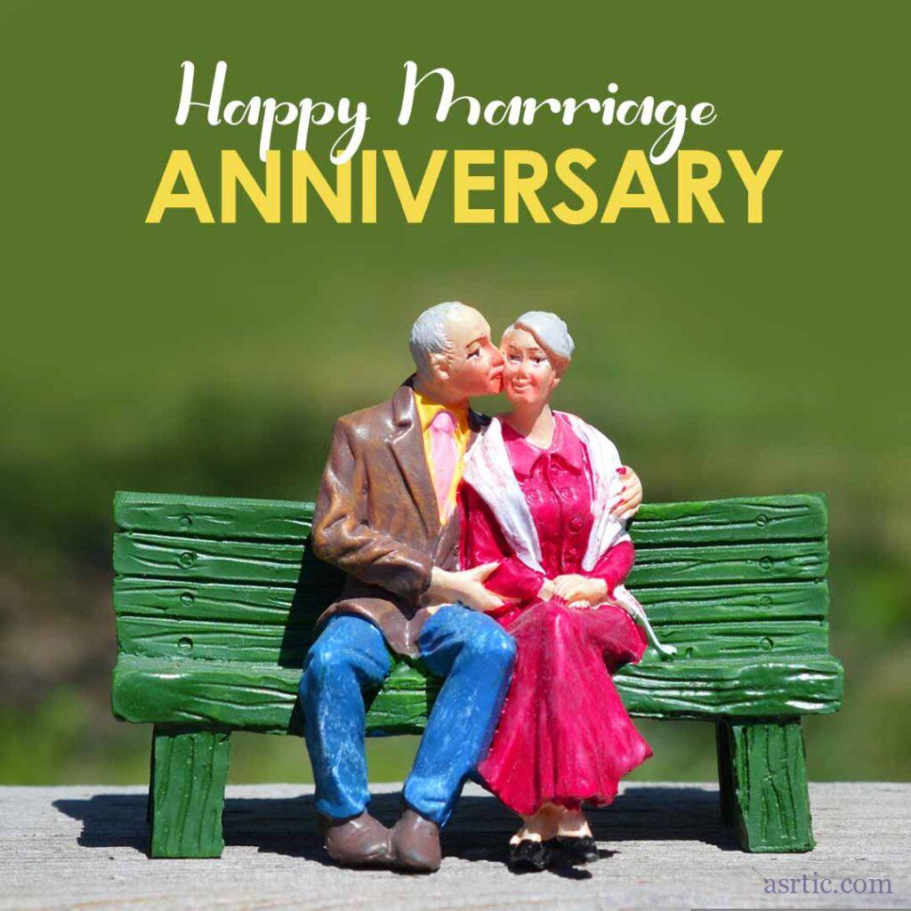 A statue depicts an elderly couple enjoying their anniversary while sitting on a bench.