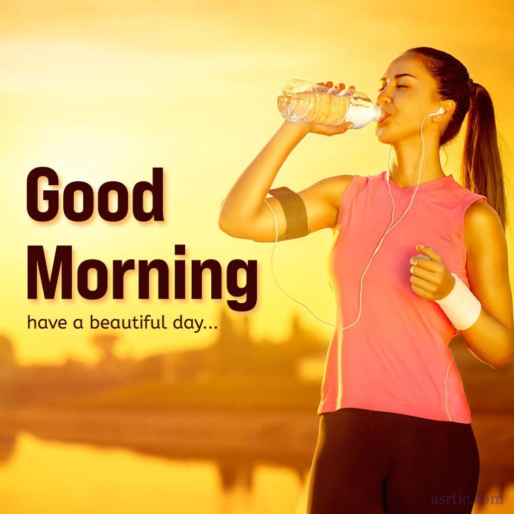 A young woman walking early in the morning while jogging and drinking water