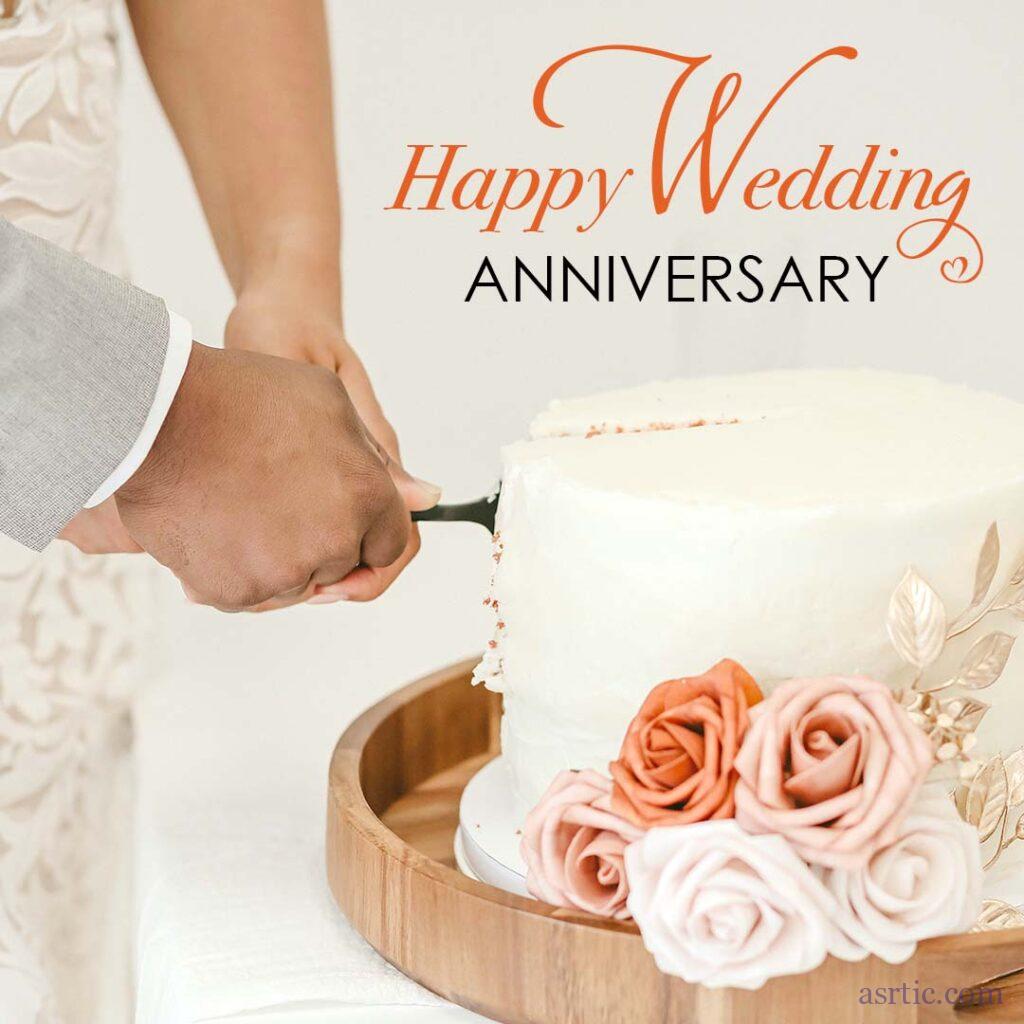 A happy couple is cutting a beautifully decorated cake with flowers and an inspiring anniversary quote