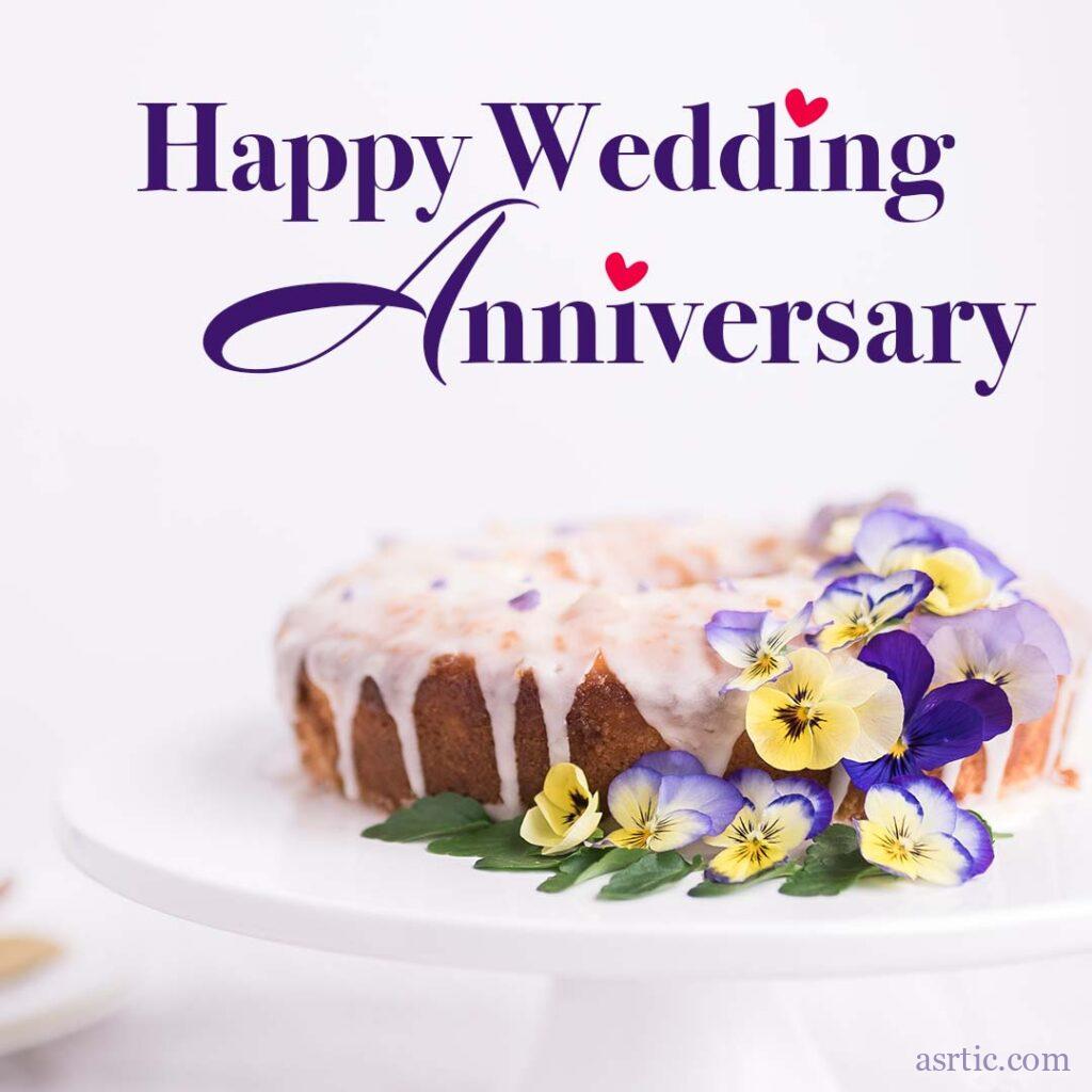 A beautifully decorated cream dripping cake with purple and yellow themed flowers and an anniversary quote