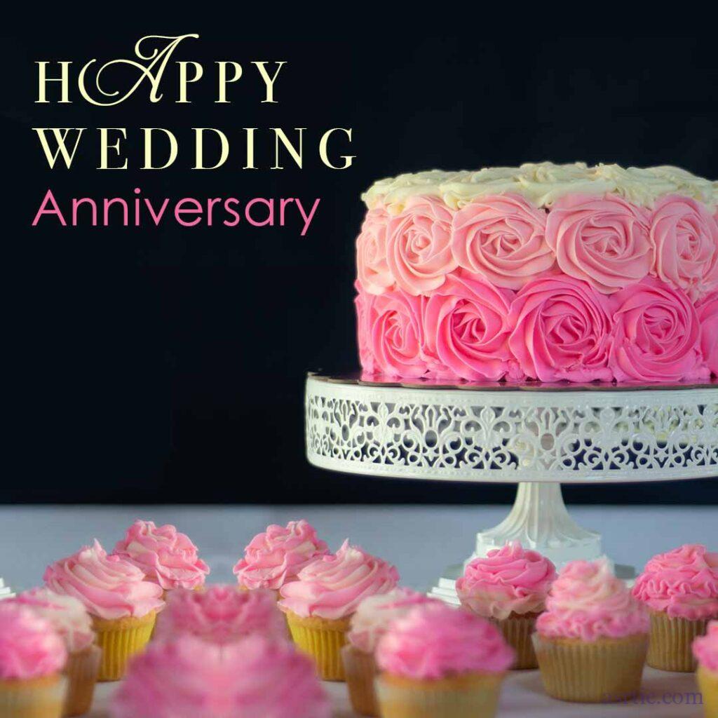 A beautiful pink and white wedding anniversary cake with delicious cupcakes on a white plate.